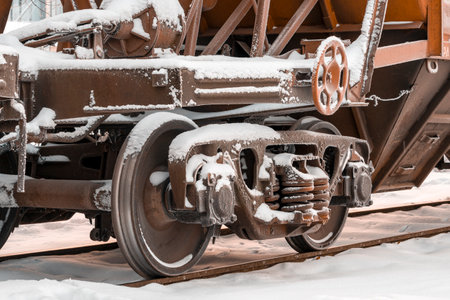 A close up view of the wheels of a cargo train. Cold winter weather.の写真素材