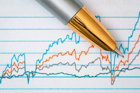 Pen showing diagram on financial report/magazine. Selective focus on pen.の写真素材