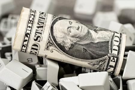 One dollar banknote on the pile of PC keyboard keys.Online trading.