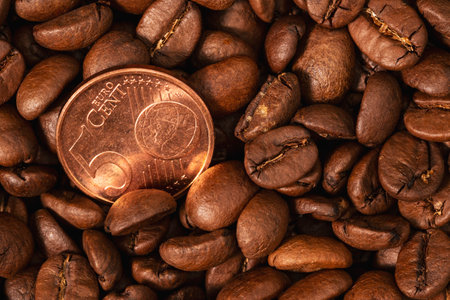 Europe coffee market. Roasted coffee beans and one five euro cent coin close-upの写真素材