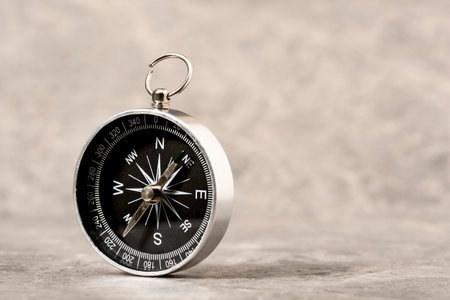 Magnetic compass on a grey stone background. Concept of global travel , tourism and exploration. Copy space.の写真素材