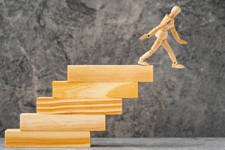 Wooden mannequin falling down from stairs. Accident failure and fiasco in business concept.