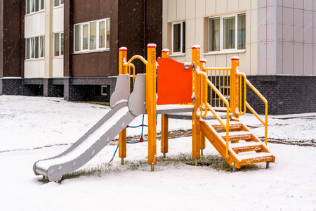 Children's play complex playground with slides and stairs in the winter city. Organization of child development.の写真素材
