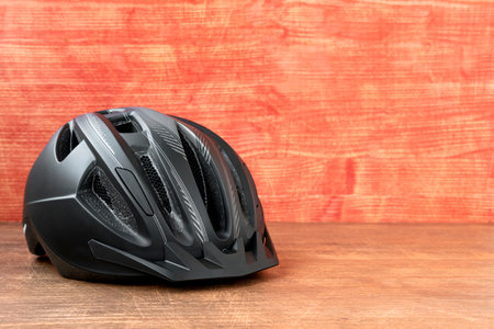 Black bicycle helmet.Mountain bike helmet on the wooden background. Copy-space.の写真素材