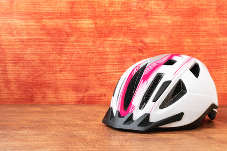 White and red color bicycle helmet.Mountain bike helmet on the wooden background. Copy-space.の写真素材