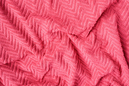 Undulating plush bath towel fabric. Pink fabric and texture concept - close up of a towel terry...
