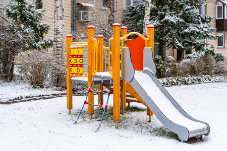 Play complex playground with slides and stairs in the winter city. Organization of child development.の写真素材