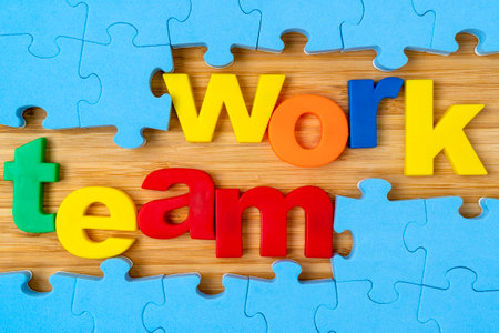 Teamwork concept business.Blue puzzle frame and color lettering TEAMWORK.の写真素材