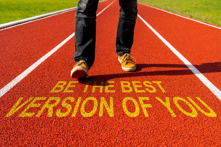 Man walks on the running track with written motivational quote - Be The Best Version of Youの写真素材