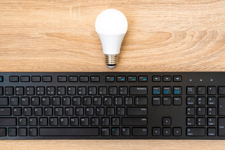 Idea and ââinspiration for innovation technology in the future.A light bulb and computer keyboard. Knowledge, creativity, future ideas for startup. Optimize technology processes for business.の写真素材