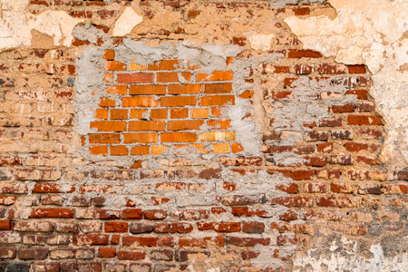 Red brick old shabby wall for background.Texture of old red brick wall surface with cement and...