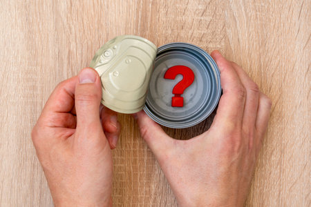 Hands open tin can in which is a question mark symbol.の写真素材