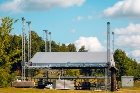 Building of outdoor concert stage on the rural landscape. Metal frame construction for light, sound...