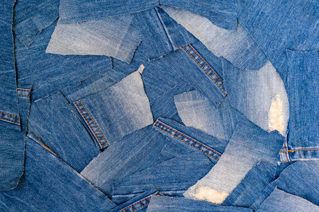 Recycling old jeans.Denim fabric for background and fashion wallpaper. DIY from jeans. Denim...