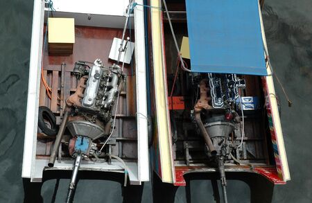 Thai longtail boats beside the River Kwai bridge, Kanchanaburi, Thailand.の写真素材