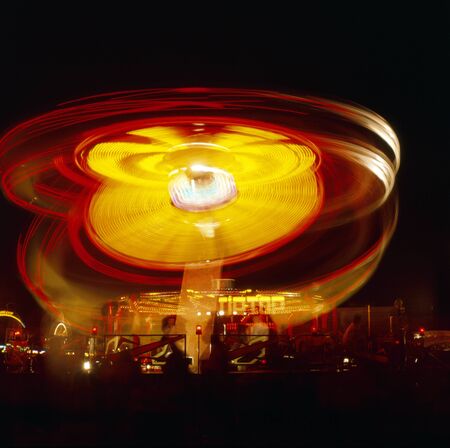 Kingston upon Hull fair at night with fairground ride movement, Hull, East Riding of Yorkshire, UK.