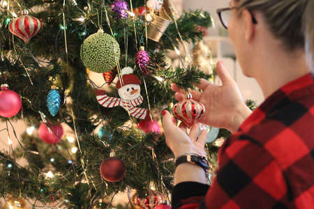 Woman preparing the christmas treeの写真素材
