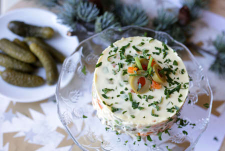 Traditional Russian salad with vegetable and meat on Christmas backgroundの写真素材