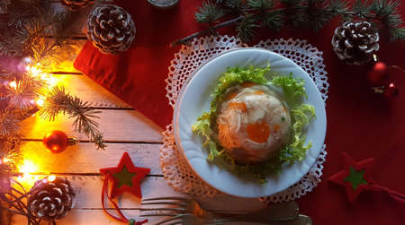 Aspic jellied meat with vegetables on Christmas backgroundの写真素材