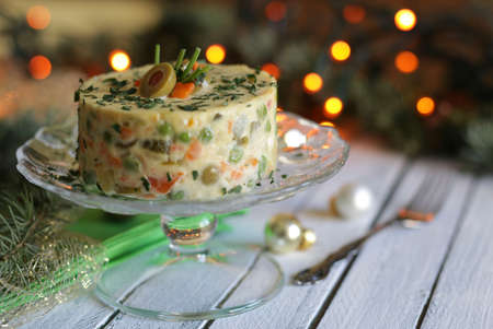 Traditional Russian salad with vegetable and meat on Christmas backgroundの写真素材