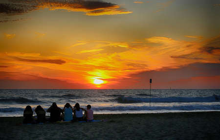 Italy, Tuscany region.People on the beach at sunsetの写真素材