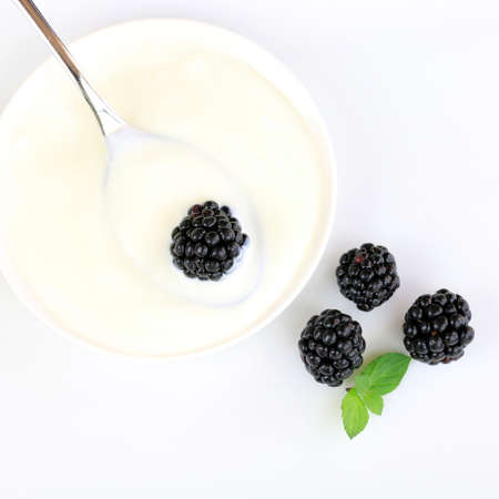 Spoon of yogurt with berries on white background. Top viewの写真素材