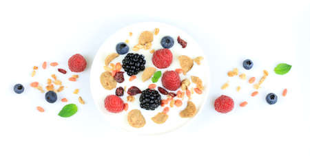 Yogurt with berries and cereals on white background. Top viewの写真素材