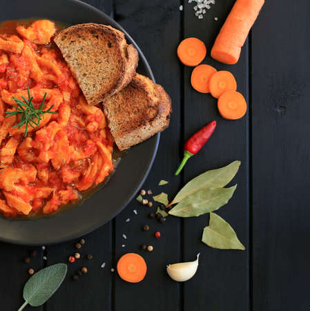 Concept of italian food. Florentine tripe with bread croutons on wooden tableの写真素材