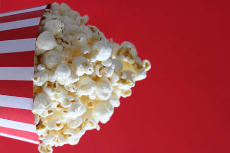 Popcorn in a bag on red backgroundの写真素材