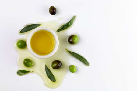 Fresh olives and olive oil on white backgroundの写真素材