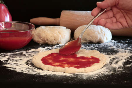 Homemade pizza. Ingredients for making italian pizza on dark background.の写真素材
