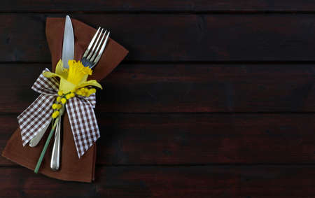 Easter decoration with cutlery on wooden table