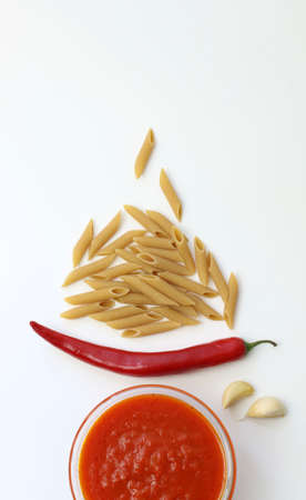 Italian tomato sauce with basil and whole wheat pasta on white backgroundの写真素材