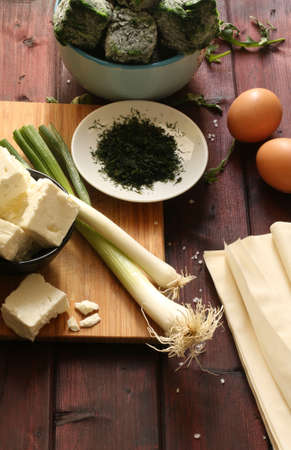 Traditional greek cuisine. Top view of ingredients for Spanakopita pie with spinach and feta cheese...