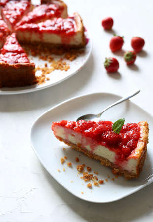 Slice of strawberry cheesecake on white background, selective focus. Sweets concept.の写真素材