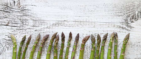 Concept of healthy food. Top view of fresh green asparagus on wooden background.の写真素材