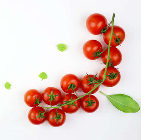 Top view of fresh tomatoes and basil isolated on white background.の写真素材
