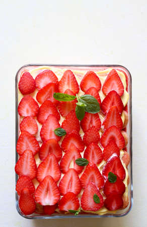 Italian dessert concept. Homemade strawberry tiramisu on white background. Top view.の写真素材