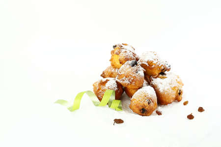 Concept of italian food. Top view of homemade traditional carnival sweets: carnival italian fritters with sultanas on white background. Copy space.の写真素材