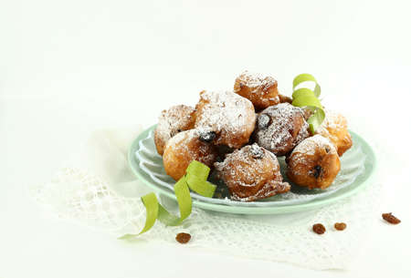 Concept of italian food. Top view of homemade traditional carnival sweets: carnival italian fritters with sultanas on white background. Copy space.の写真素材