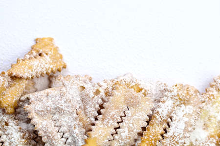 Top view of homemade traditional carnival sweets: chat on white background. Copy space.