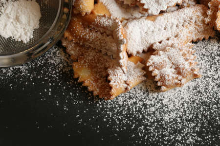 Top view of homemade traditional carnival sweets: chat on dark background. Copy space.の写真素材