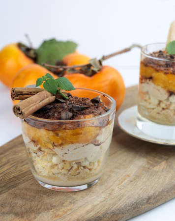 Delicious dessert with persimmon fruit and cinnamon.の写真素材