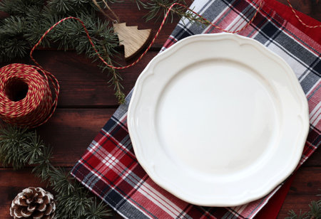 Christmas food border with white plate on wooden background. Top view. Copy space.の写真素材