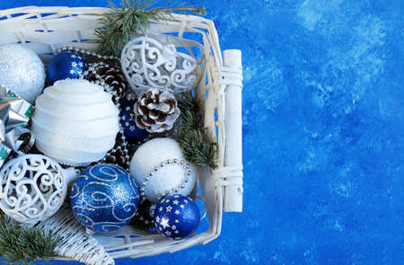 Christmas decorations in a basket. Blue background. View from above.の写真素材