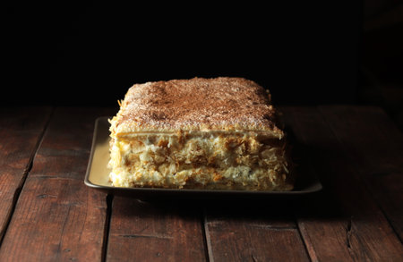 Millefeuille dessert isolated on dark background. French cuisine. Copy space.