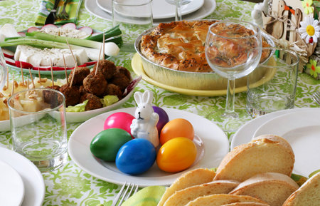 Concept of spring holiday.Easter table decoration. Eggs basket, spring flowers and bunny decor....