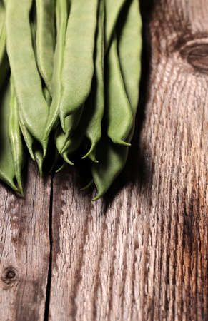 Green beans platters isolated on wooden background. Jackdaws. Top view, copy space.