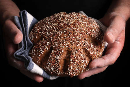 Cereal bread isolated on dark background. Healthy food. Closeup, copy space.