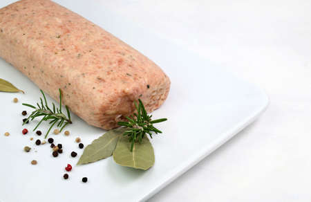 Raw meatloaf on white background. Top view. Copy space.